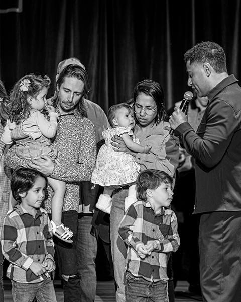 Parents holding baby during dedication ceremony at church